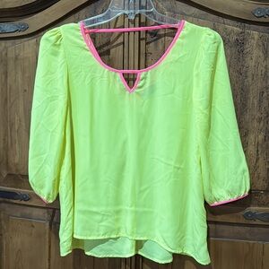 Bright yellow top with pink neck outline by Daytrip